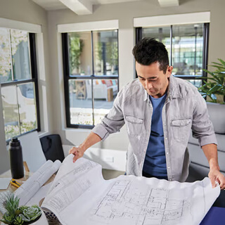 Architect looking over blueprints